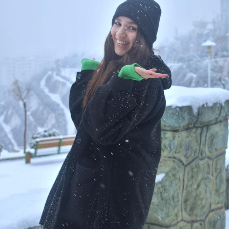 Avery Chen, Lead Design Curator at PebbleCrestOak, reviewing corporate floral arrangements